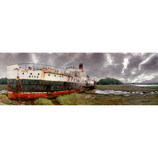 An old, rusting paddle steamer beached on a muddy riverbank under a cloudy sky on the Isle of Wight, captured in stunning detail by Available Light Photography's The Ryde Queen.