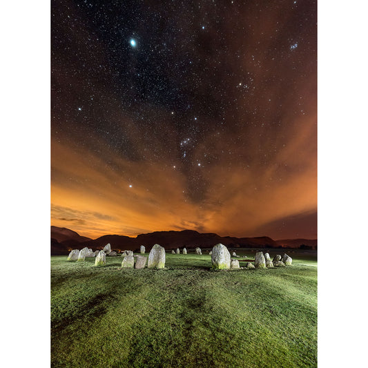 Orion over Castlerigg Stone Circle by Available Light Photography with illuminated clouds at twilight.