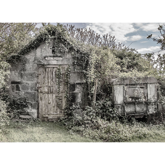 Abandoned Little Stenbury stone building and old caravan on the Isle of Wight, overgrown with vegetation by Available Light Photography.