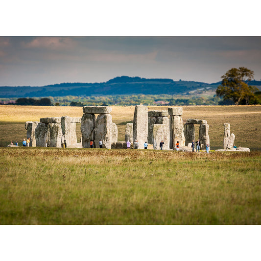 Visitors exploring the ancient Available Light Photography Stonehenge monument on a grassy plain in Wight.