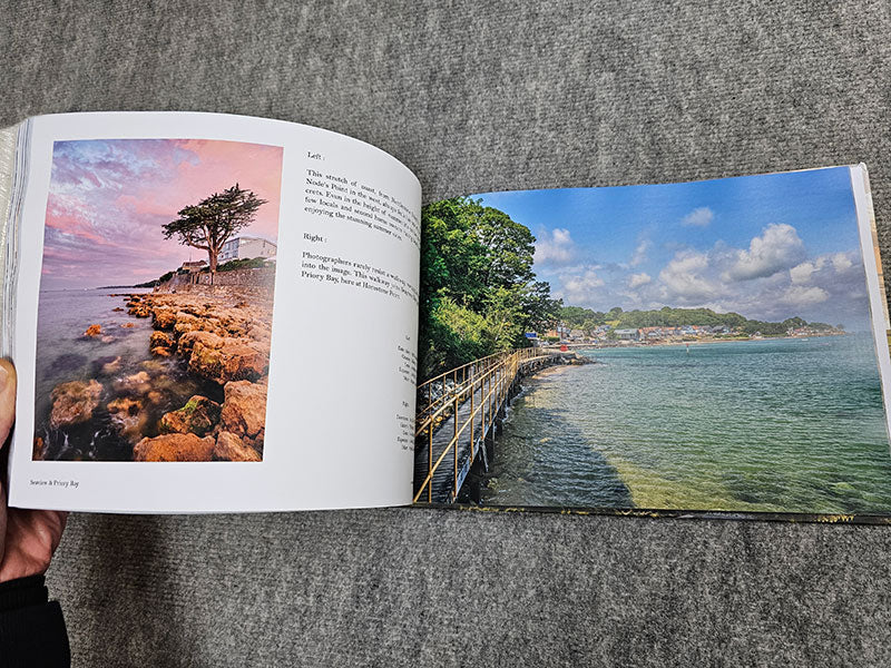 The Available Light Photography book by Available Light Photography showcases stunning landscape photos: a rocky shoreline at sunset on the left page, and a serene coastal walkway on the right, both masterfully capturing natural beauty through expert light usage.