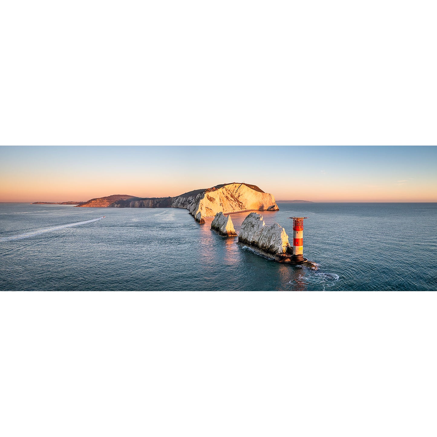 Aerial view of The Needles lighthouse near a rocky coastline at sunset on Wight by Available Light Photography.