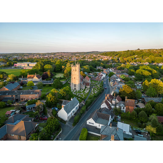 Aerial view of a quaint Carisbrooke village with a prominent church tower at dusk captured by Available Light Photography.