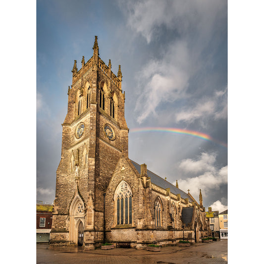 A Newport Minster at the Isle of Wight under a sky with a partial rainbow, captured by Available Light Photography.