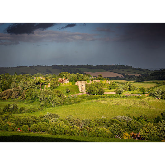 A rural landscape on the Isle of Wight with Carisbrooke Castle ruins amid verdant fields under a stormy sky, captured by Available Light Photography.