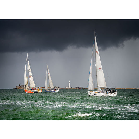 Sailboats racing in choppy waters near the Isle of Wight with an approaching storm in the background captured by Available Light Photography at the Round the Island Race.