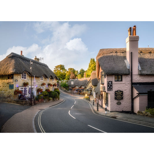 Shanklin Old Village street with traditional thatched-roof cottages at dusk by Available Light Photography.