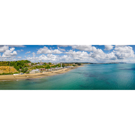 A panoramic aerial view of Shanklin & Sandown Bay's coastal landscape with a beachfront, clear blue waters, and scattered clouds above by Available Light Photography.