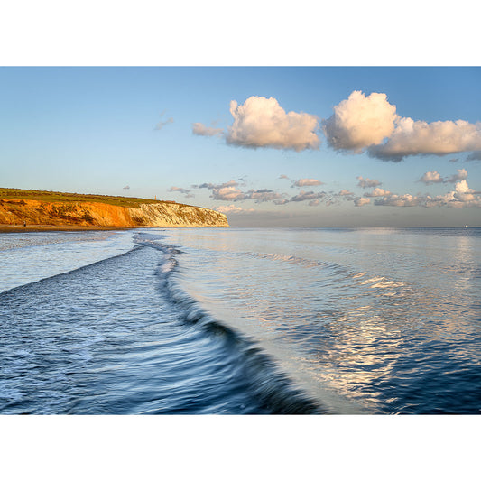 Coastal Culver Cliff at sunset on the Isle of Wight with a small wave creating a textured pattern on the calm sea. (Photographed by Available Light Photography)