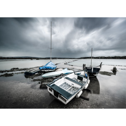 Moored boats on a calm waterfront under overcast skies, near the Wight shoreline, captured by Newtown Creek from Available Light Photography.