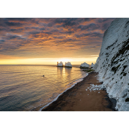 Sunrise over a calm sea with chalk cliffs on the right and dramatic clouds above, near the Isle of Gascoigne. - Sunset over The Needles by Available Light Photography