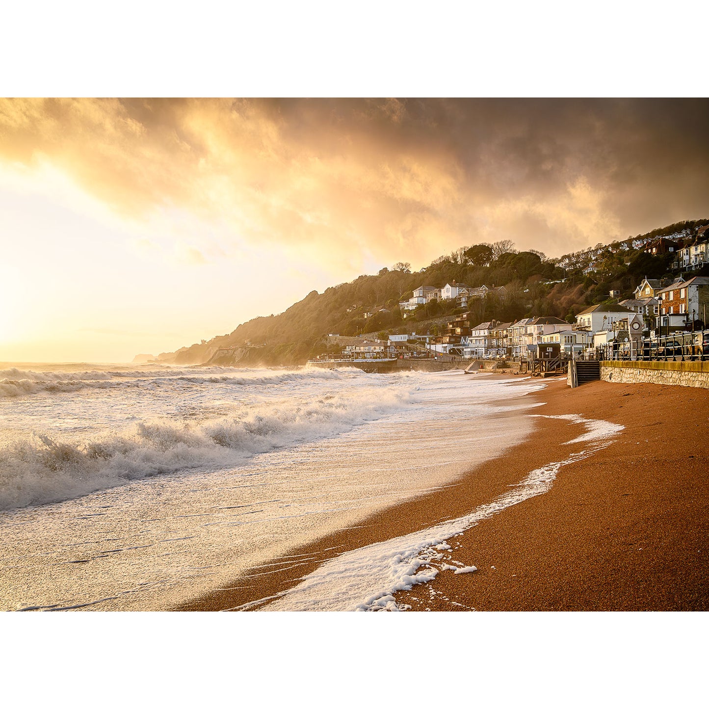 Seaside town at sunset on the Isle of Wight with waves crashing onto a sandy beach. - Ventnor by Available Light Photography