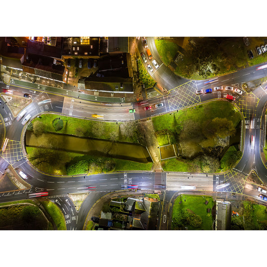 Image: Aerial night view of Coppins Bridge, Newport urban park flanked by roads with vehicle light trails taken by Available Light Photography.