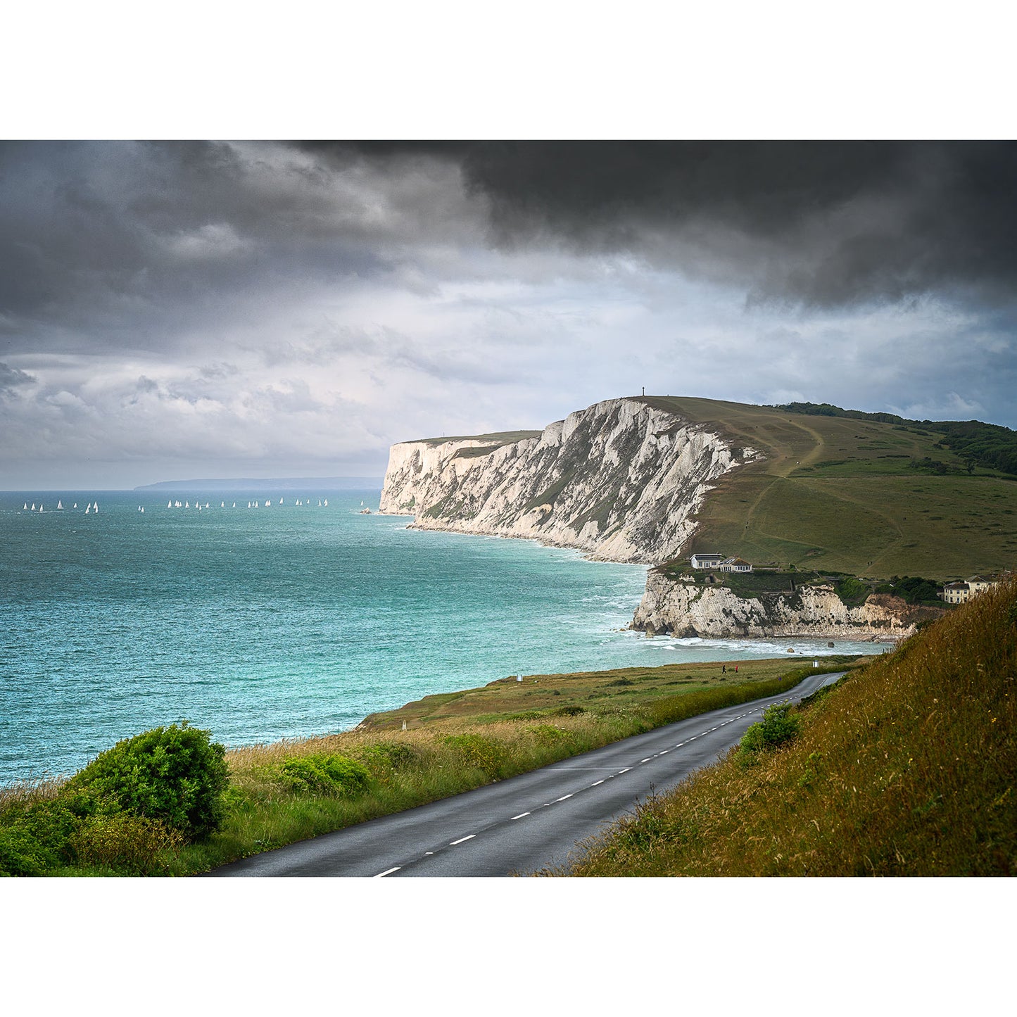 Round the Island Race, Tennyson Down by Available Light Photography captures sailboats gliding past dramatic white chalk cliffs and a turquoise sea beneath a cloudy sky on this scenic coastal route.