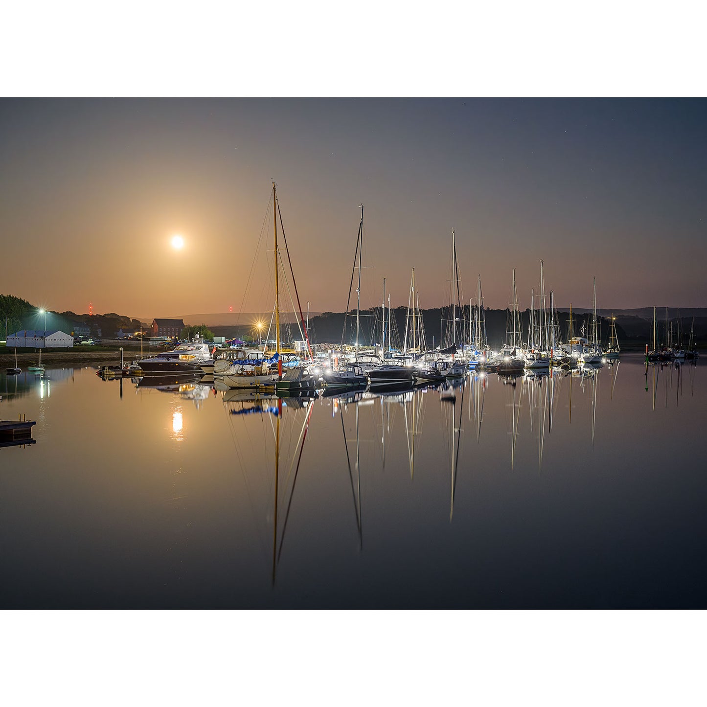 Moonrise, Yarmouth" by Available Light Photography captures a peaceful marina at night—sailboats docked, their reflections shimmering on calm water under a luminous full moon.