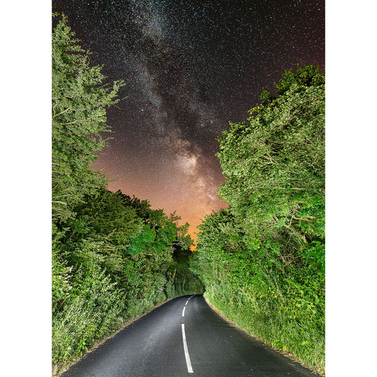 A starry night sky over Road to the Stars, Milky Way at Knighton flanked by lush trees on the Isle of Wight captured by Available Light Photography.