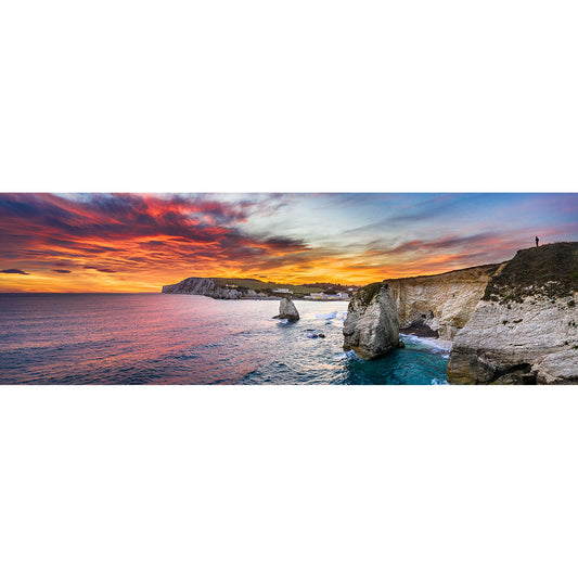 A panoramic view of Freshwater Bay on the Gascoigne Isle of Wight with towering cliffs and a colorful sky by Available Light Photography.