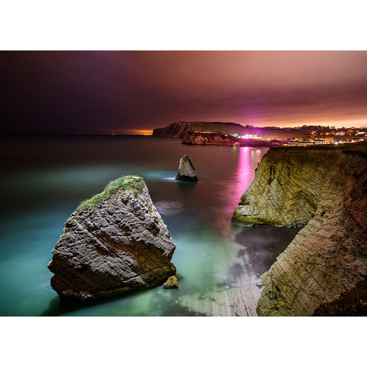 Nighttime coastal scenery at Freshwater Bay with illuminated rocks and a glowing horizon, captured by Available Light Photography.