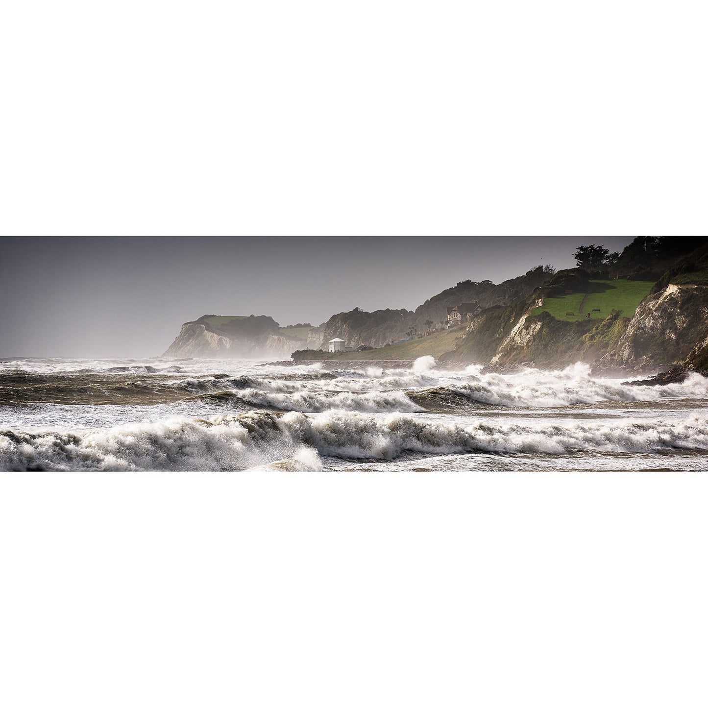 Rough waves crashing against the rugged coastline of Isle Gascoigne under an overcast sky captured by Storm Brian, Ventnor from Available Light Photography.