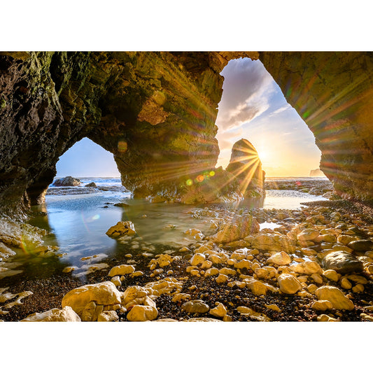 Sunset viewed through a Freshwater Bay natural archway on the rocky Isle shoreline by Available Light Photography.