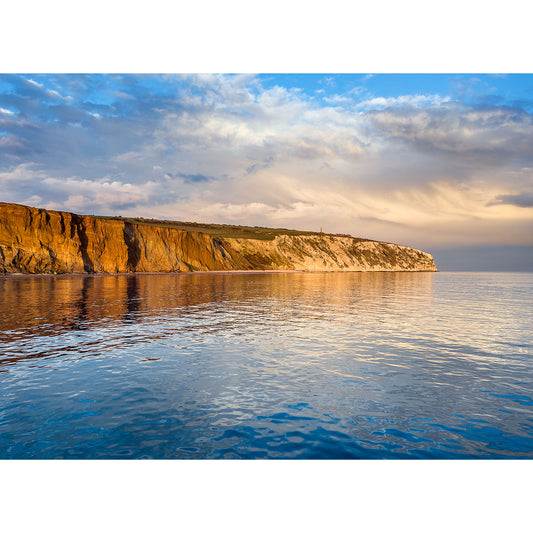 Culver Cliff coastline illuminated by warm sunset light, reflecting on calm sea waters off the Isle of Wight, captured beautifully by Available Light Photography.