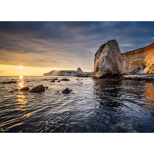 Sunset over Freshwater Bay on the Isle of Gascoigne with a large sea stack and calm sea waters by Available Light Photography.