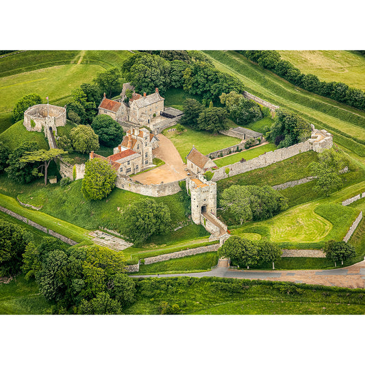 Aerial view of Carisbrooke Castle, an ancient hilltop fortress on the Isle with surrounding grassy fields, captured by Available Light Photography.
