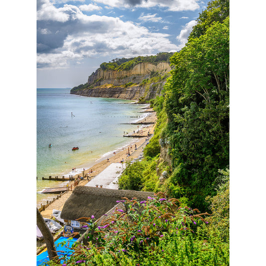 Shanklin beach scene on the Isle of Wight with visitors enjoying the water and sandy shore under a partly cloudy sky, captured by Available Light Photography.