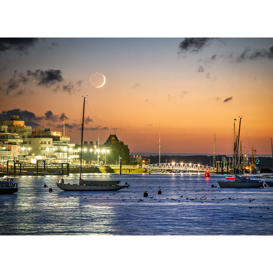 Crescent Moon over Cowes by Available Light Photography, featuring a tranquil marina at dusk with lit waterfront buildings and moored boats on the Isle of Wight.