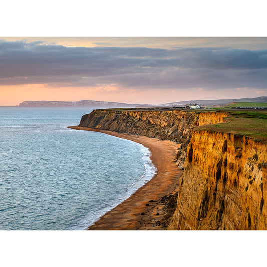 Coastal cliff at sunset with a golden beach curving along the Isle of Wight shoreline, captured by Chale from Available Light Photography.