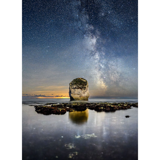A lone rock stands in shallow water under a starry night sky with the Milky Way visible, near the Isle of Gascoigne captured by Available Light Photography's Freshwater Bay.