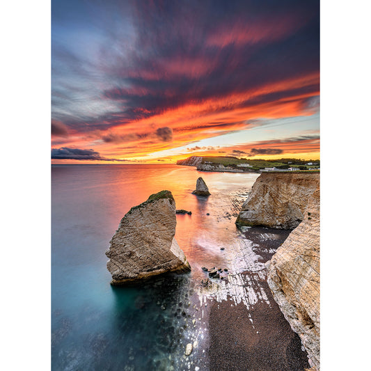A vibrant sunset over a coastal landscape with rock formations at Freshwater Bay on the Isle of Wight, captured by Available Light Photography.