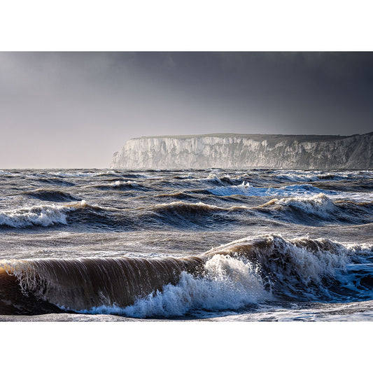 Choppy Stormy Seas waves with a backdrop of sheer white cliffs under a moody sky at the Isle of Wight captured by Available Light Photography.