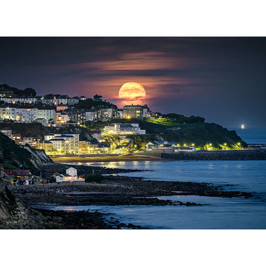 A Moonrise over Ventnor rising over a coastal town at twilight on the Isle of Wight by Available Light Photography.