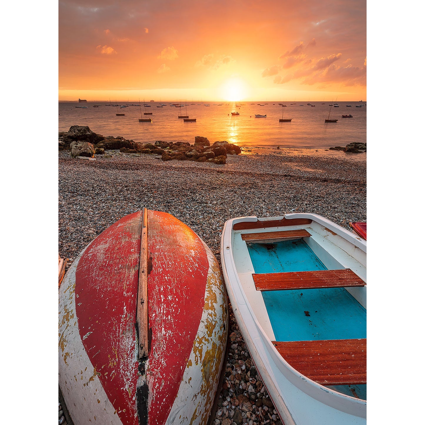 Sunset at the seaside with boats on the shore of Seaview by Available Light Photography.