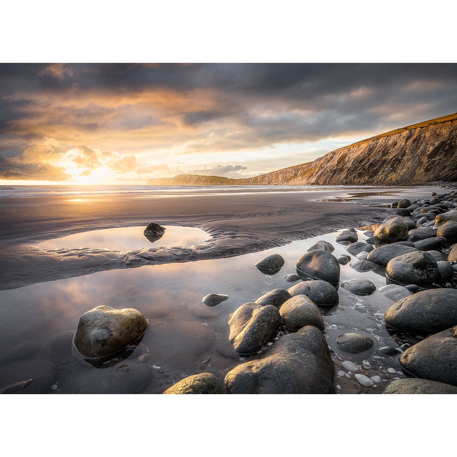 Sunset on Compton Bay with tide pools and a rocky shoreline on the Isle of Wight by Available Light Photography.