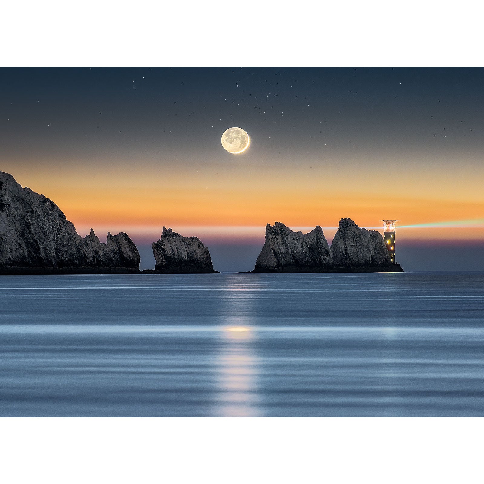 Full Crescent Moon over a tranquil sea with cliff formations and a lighthouse on Gascoigne Isle captured by Available Light Photography.