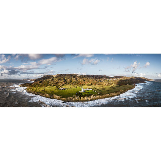 A panoramic aerial view of St. Catherine's Point on the Isle of Wight, with waves lapping against the shoreline and a lighthouse on a verdant peninsula, captured by Available Light Photography.