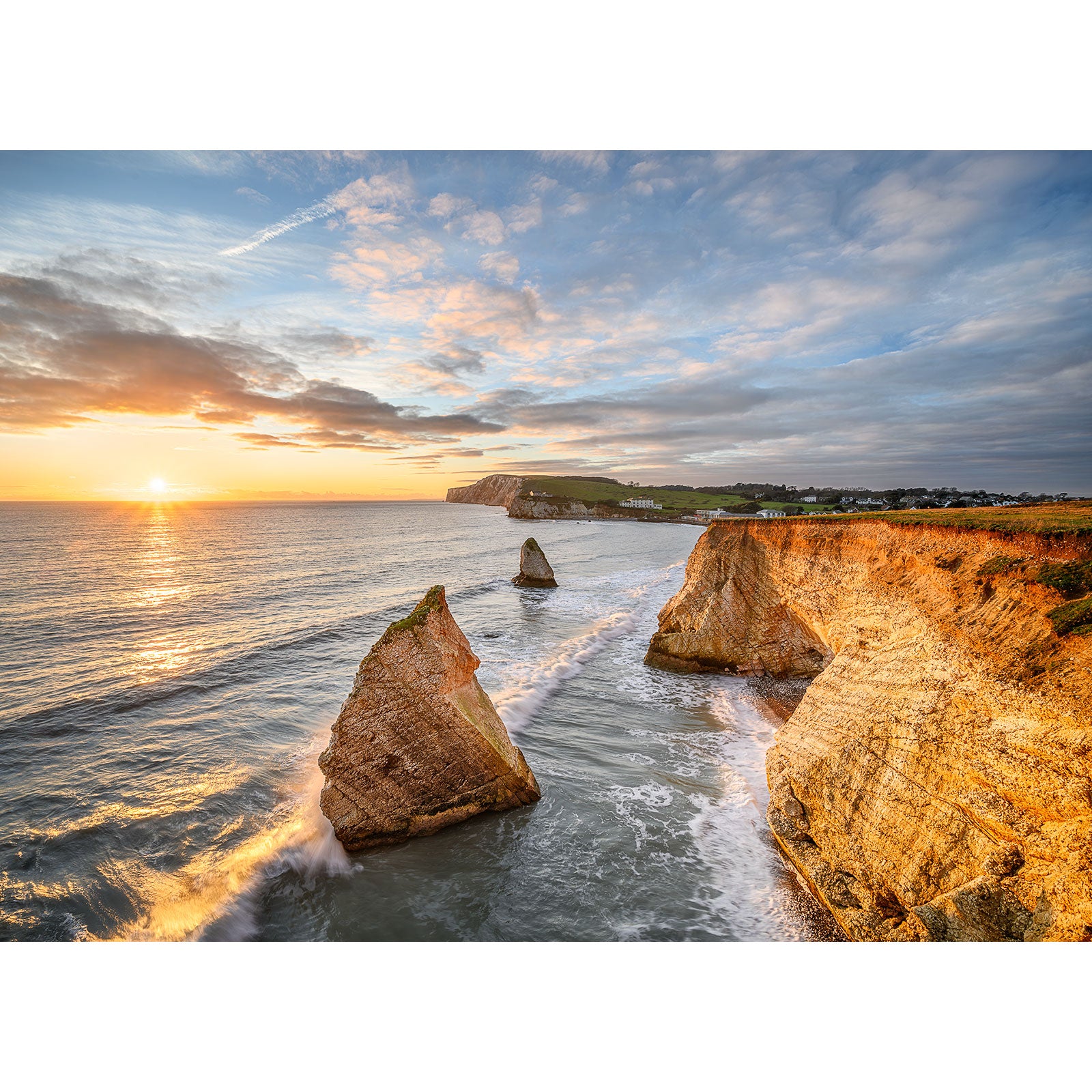Sunset at Freshwater Bay on the Isle of Wight with sea stacks and crashing waves by Available Light Photography.