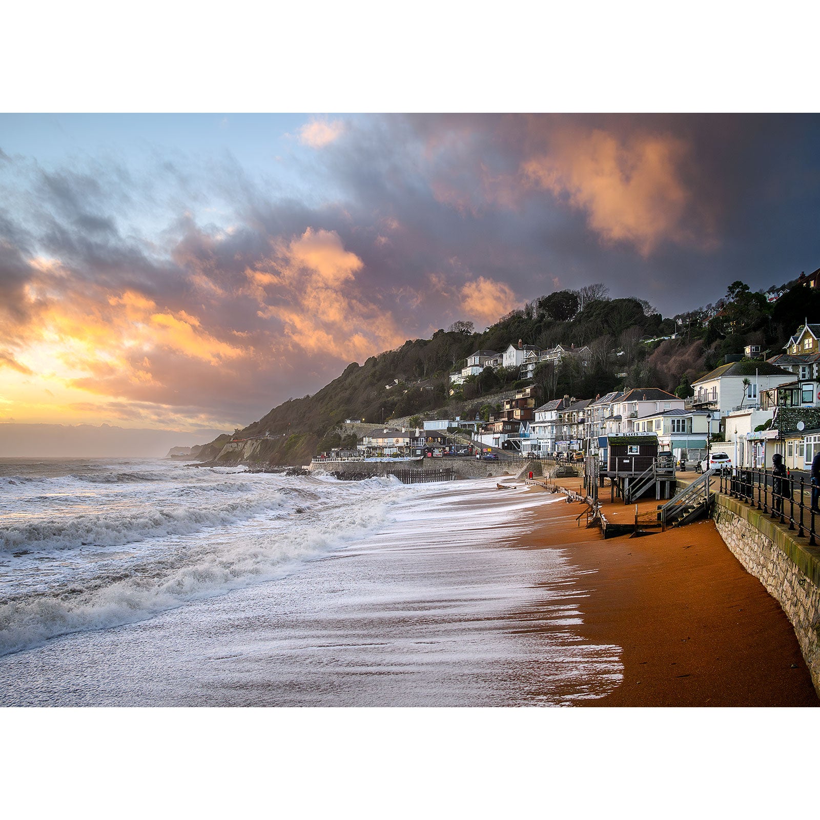 Sunset over the coastal town of Ventnor with waves crashing on the beach, captured by Available Light Photography.