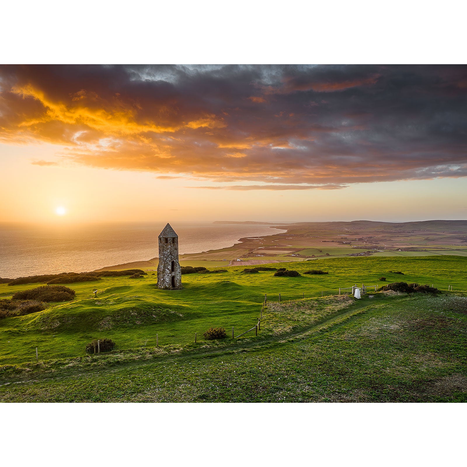 An ancient tower overlooking a coastal landscape at sunset is challenging to extract relevant SEO keywords without a descriptive St. Catherine's Oratory product description beyond the image number.