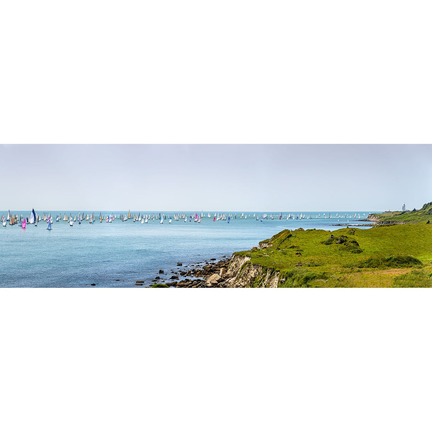 Round the Island Race, St. Catherine's Point by Available Light Photography captures grassy cliffs overlooking sailboats with colorful sails on a calm blue sea beneath a clear sky.