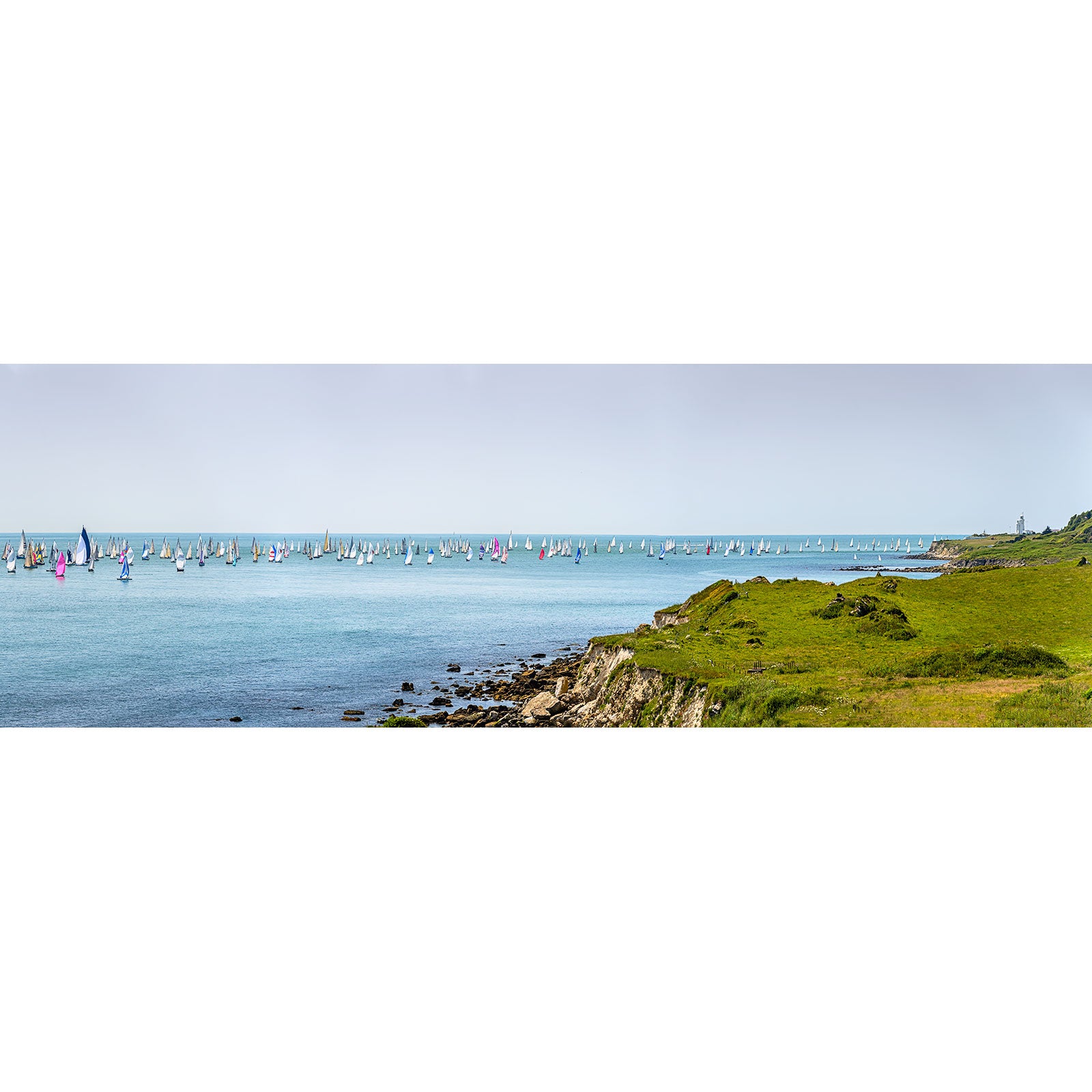 Round the Island Race, St. Catherine's Point by Available Light Photography captures grassy cliffs overlooking sailboats with colorful sails on a calm blue sea beneath a clear sky.