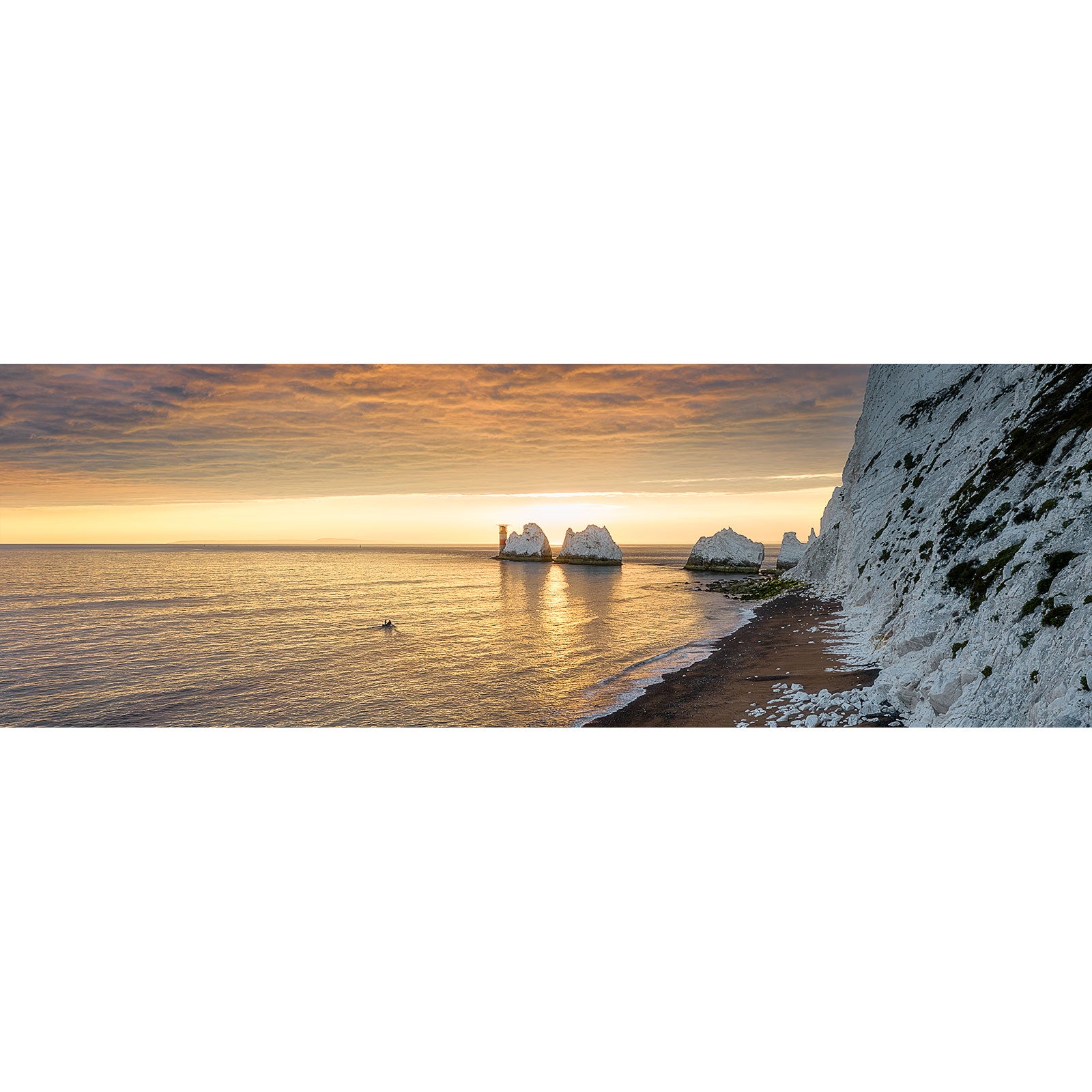 The Needles by Available Light Photography features iconic white chalk stacks rising from calm waters at sunset, with a small boat near the shore under a golden sky.