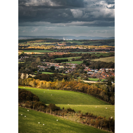 Looking North over Wroxall" by Available Light Photography displays a countryside scene with green fields, grazing sheep, village clusters, and a distant city skyline beneath a cloudy sky.