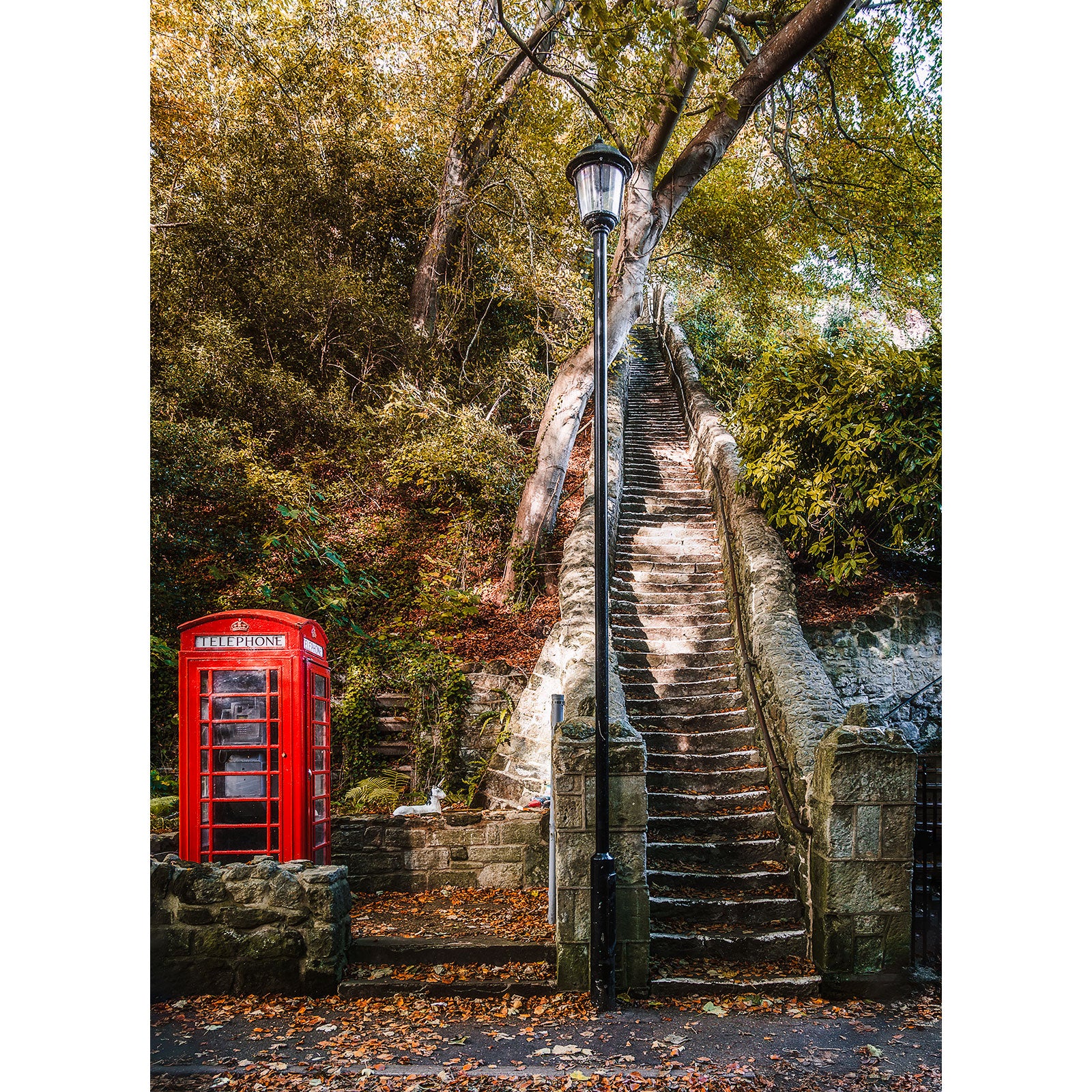 Bonchurch by Available Light Photography features a classic red British phone booth, a tall stone staircase, trees, greenery, and a street lamp—but the product description lacks sufficient detail for identifying SEO keywords.