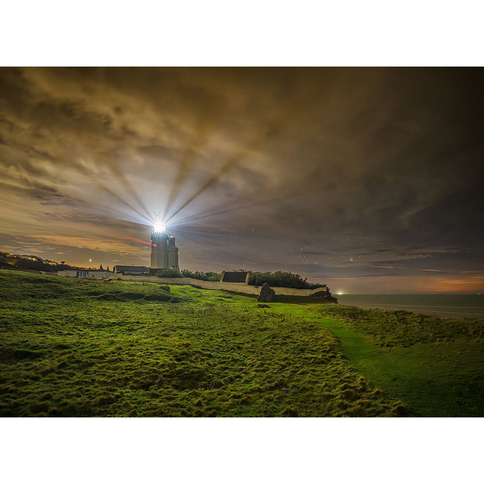 Image number 3102 by Available Light Photography showcases St. Catherine's Lighthouse with its beacon shining brightly from the top.