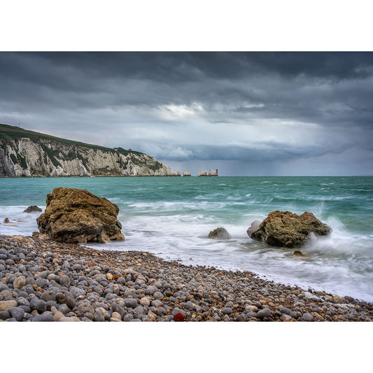 Image number 3110, "The Needles" by Available Light Photography, captures dramatic white cliffs beneath a cloudy sky, with waves washing over large stones along a rocky shoreline.