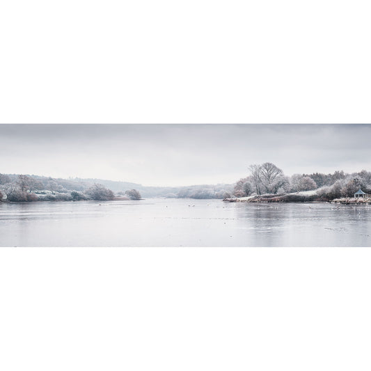 A serene winter scene, "The Old Mill Pond, Wootton Creek" by Available Light Photography, features a calm river and frost-covered trees on a cold, overcast day, capturing a tranquil and muted landscape.