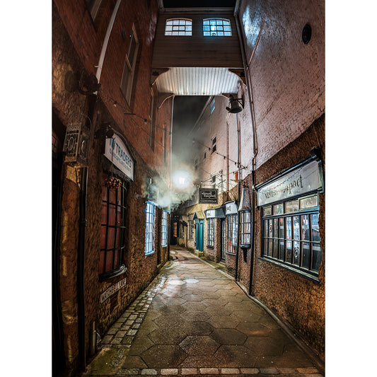 Watchbell Lane, Newport by Available Light Photography captures a narrow cobblestone alley at night, with glowing shop signs, lit windows, brick walls, and swirling mist beneath an archway illuminated by a streetlamp.